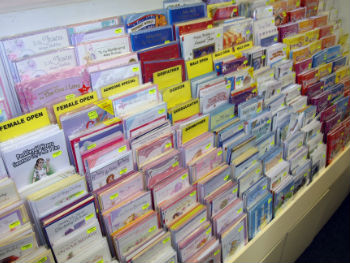 A selecton of greeting cards in a rack ready for sale