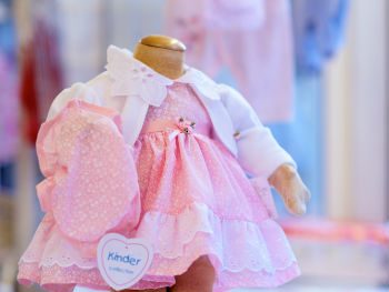 Image of a pink baby's dress and white cardigan